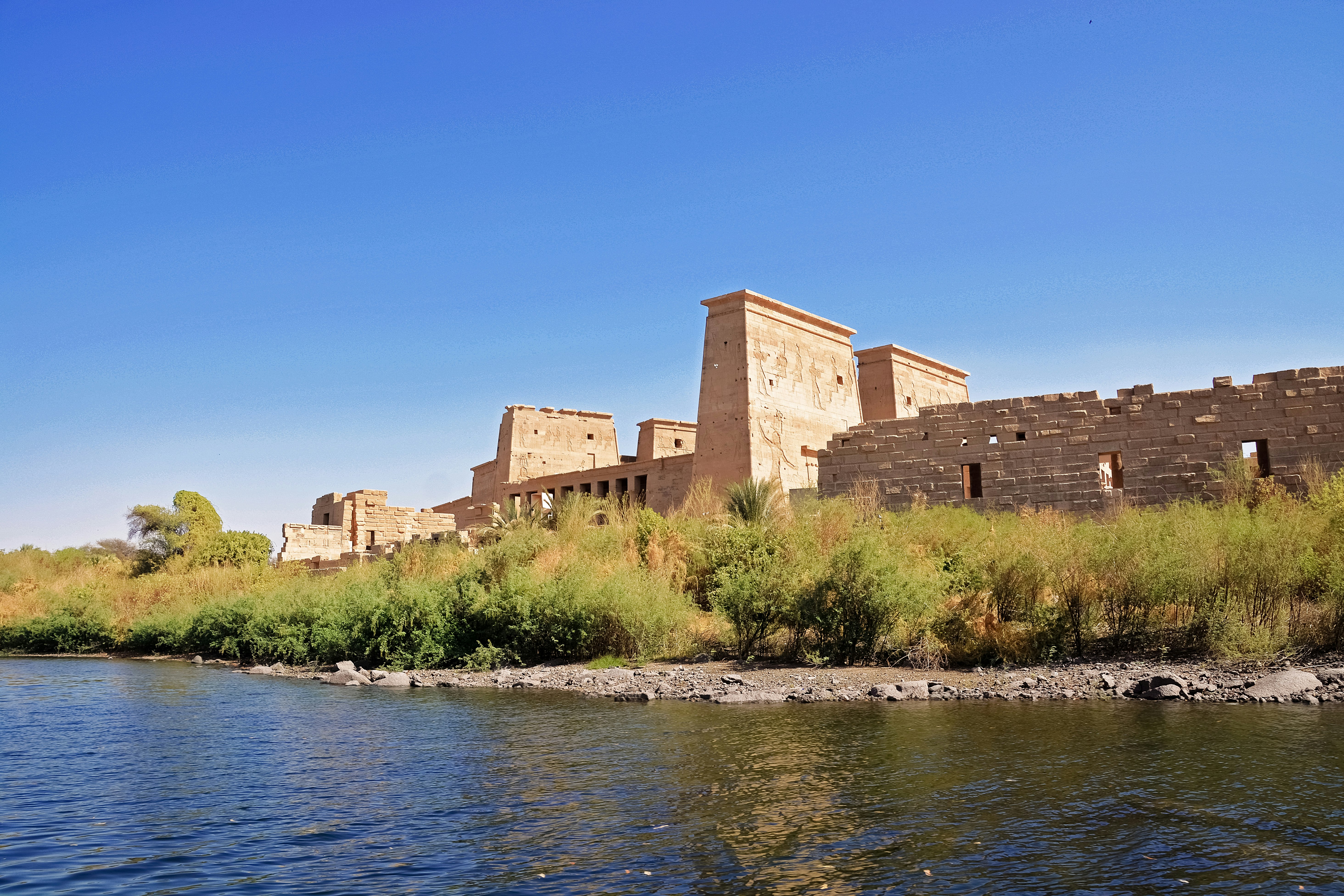 brown concrete building near body of water during daytime